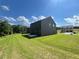 Exterior view of the home showcasing the siding and large, grassy backyard, ideal for outdoor enjoyment at 657 Egrets Landing #54, Covington, GA 30014