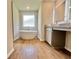 A luxurious bathroom featuring a standalone bathtub, a sleek vanity, and wood-look tile flooring at 657 Egrets Landing #54, Covington, GA 30014