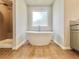 An elegant bathroom with a freestanding tub, a rain shower and vanity with a light granite countertop at 657 Egrets Landing #54, Covington, GA 30014