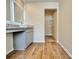 A vanity area with gray cabinets, a light countertop and tiled floors with a closet in view at 657 Egrets Landing #54, Covington, GA 30014