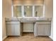 A large vanity with double sinks, gray cabinets, light countertop and wood-look tiled floors at 657 Egrets Landing #54, Covington, GA 30014