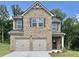 Charming two-story brick home featuring a two-car garage and well-maintained landscaping at 657 Egrets Landing #54, Covington, GA 30014