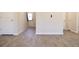 Spacious living room showing multiple doors and stairs with light colored walls and sleek flooring at 657 Egrets Landing #54, Covington, GA 30014