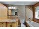 Bathroom with granite countertops, decorative mirror, and tiled shower-tub combo at 955 Laurel Mill Dr, Roswell, GA 30076