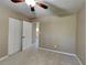 Neutral bedroom featuring a ceiling fan, carpeted floor, and a double door closet at 955 Laurel Mill Dr, Roswell, GA 30076