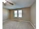 Bright, airy bedroom with two windows offering natural light and plush carpeting at 955 Laurel Mill Dr, Roswell, GA 30076