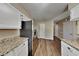 Well-lit kitchen featuring stainless steel appliances, granite countertops, and white cabinets at 955 Laurel Mill Dr, Roswell, GA 30076
