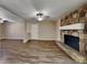 Cozy living room featuring wood-look floors and a stone fireplace at 955 Laurel Mill Dr, Roswell, GA 30076