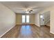 Spacious living room featuring wood-look floors, a ceiling fan, and abundant natural light through the windows at 955 Laurel Mill Dr, Roswell, GA 30076