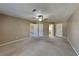 Spacious carpeted main bedroom with ceiling fan and multiple closets for ample storage at 955 Laurel Mill Dr, Roswell, GA 30076