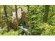 An aerial view shows the deck of the house surrounded by lush greenery at 2451 Cedar Fork Trl, Marietta, GA 30062