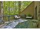 An open air deck featuring outdoor seating, providing a relaxing view of the beautiful surrounding trees at 2451 Cedar Fork Trl, Marietta, GA 30062