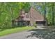 A charming two-story house with a wood exterior is surrounded by lush green trees at 2451 Cedar Fork Trl, Marietta, GA 30062