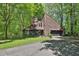 Charming home with a unique architectural design and a long driveway nestled among many lush trees at 2451 Cedar Fork Trl, Marietta, GA 30062
