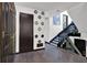 Hallway with hardwood floors, artwork, black doors, stairs to the second floor at 2451 Cedar Fork Trl, Marietta, GA 30062