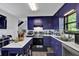 Kitchen with U-shaped layout, marble countertops, and bright blue cabinets at 2451 Cedar Fork Trl, Marietta, GA 30062