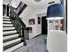 Bright foyer featuring a staircase with black and white trim and walls adorned with decorations and pictures at 2451 Cedar Fork Trl, Marietta, GA 30062