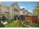Backyard view, featuring green grass, a play set, and a comfortable seating area at 2894 Cross Creek Dr, Cumming, GA 30040