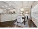 Bright dining room features an elegant chandelier, tray ceilings, and wainscoting at 2894 Cross Creek Dr, Cumming, GA 30040