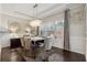Bright dining room features an elegant chandelier, tray ceilings, and wainscoting at 2894 Cross Creek Dr, Cumming, GA 30040