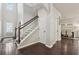 Bright foyer with hardwood floors, staircase, and an open doorway to the dining room at 2894 Cross Creek Dr, Cumming, GA 30040