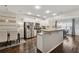 Eat in kitchen with stainless steel appliances, white cabinets, granite countertops, and modern lighting at 2894 Cross Creek Dr, Cumming, GA 30040