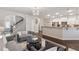 Spacious living room with hardwood floors, an open layout connecting to the kitchen, and modern lighting at 2894 Cross Creek Dr, Cumming, GA 30040