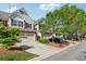 A row of townhouses with attached garages line a street in a well-kept community at 2894 Cross Creek Dr, Cumming, GA 30040