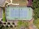 Aerial view of community tennis court surrounded by lush greenery and landscaping at 2894 Cross Creek Dr, Cumming, GA 30040