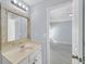 Bright bathroom featuring a vanity with a rustic framed mirror and a bright light fixture at 5013 Centennial Commons Nw Dr, Acworth, GA 30102