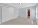 A carpeted bedroom with a closet and an open door to the bathroom at 5013 Centennial Commons Nw Dr, Acworth, GA 30102