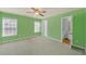 Bright green bedroom with carpet, a ceiling fan, a large window, and an attached bathroom at 5013 Centennial Commons Nw Dr, Acworth, GA 30102