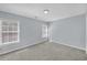 This carpeted bedroom has large windows, neutral walls, and a ceiling light fixture at 5013 Centennial Commons Nw Dr, Acworth, GA 30102