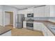 Well-lit kitchen with stainless steel appliances and white cabinets providing a modern look at 5013 Centennial Commons Nw Dr, Acworth, GA 30102