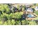 Expansive backyard featuring a pool, patio, deck, utility shed, mature trees, and lush landscaping at 60 Bartlett Way, Dallas, GA 30157
