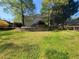 Large green backyard featuring tiered garden and a glimpse of the home's rear at 60 Bartlett Way, Dallas, GA 30157