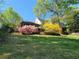 Lush backyard showcasing mature trees, landscaping, and an exterior view of the home at 60 Bartlett Way, Dallas, GA 30157