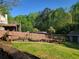 Backyard view showing the garden, wooden fencing, shed, and lush landscaping at 60 Bartlett Way, Dallas, GA 30157