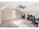 Neutral bedroom features tan carpet and walls, along with a ceiling fan and natural light at 60 Bartlett Way, Dallas, GA 30157