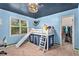 bedroom with blue walls, a hanging hammock, and a bunk bed with a slide at 60 Bartlett Way, Dallas, GA 30157