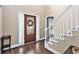 Inviting entryway with a decorative front door, beautiful hardwood floors, and an elegant staircase at 60 Bartlett Way, Dallas, GA 30157