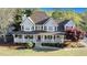 Inviting two-story home with a charming front porch, well-maintained lawn, and mature trees at 60 Bartlett Way, Dallas, GA 30157