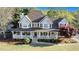 Charming two-story home featuring a welcoming front porch, and a well-manicured lawn at 60 Bartlett Way, Dallas, GA 30157