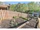 Backyard garden with raised beds, wooden fencing, and a storage shed at 60 Bartlett Way, Dallas, GA 30157