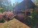 Exterior view of the back yard hot tub gazebo with a fireplace and lush landscaping at 60 Bartlett Way, Dallas, GA 30157
