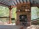 View of the hot tub gazebo with stacked stone fireplace and wood beams at 60 Bartlett Way, Dallas, GA 30157