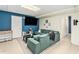 Finished basement features a comfortable green sofa, entertainment area, and lots of light at 60 Bartlett Way, Dallas, GA 30157