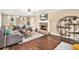Open living room featuring a stone fireplace, hardwood floors, and stylish decor at 60 Bartlett Way, Dallas, GA 30157