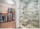 Contemporary bath features a tiled walk-in shower and linen closet that opens to a walk-in closet at 60 Bartlett Way, Dallas, GA 30157