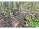 View of a small wooden bridge over a flowing stream surrounded by trees at 60 Bartlett Way, Dallas, GA 30157